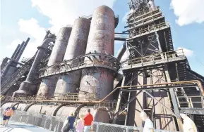  ?? APRIL GAMIZ/ MORNING CALL FILE PHOTO ?? The tour group takes in the history and views along the Hoover Mason Trestle that gives a view of the blast furnaces on south side Bethlehem during the Steeples & Steel Tour in south Bethlehem on Sept. 16, 2017.