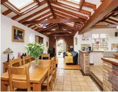  ??  ?? Clockwise from above: The open-plan kitchen leads into dining and sitting room areas; the back garden comes with AstroTurf; one of the bedrooms; owner Eileen O’Connell and the exterior of the house