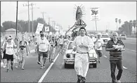  ?? AP/ERIC GAY ?? Altar server Anthoney Saenz (second from right) waves incense Saturday as he helps lead a procession toward the Rio Grande to oppose the wall the U.S. wants to build at the Mexican border.
