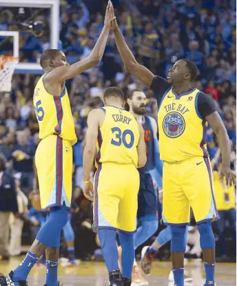  ?? REUTERS ?? Golden State Warriors forward Kevin Durant (left) is congratula­ted by forward Draymond Green after making a three-point basket against the Oklahoma City Thunder in the second quarter at Oracle Arena.