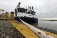  ?? GERALD HERBERT — ASSOCIATED PRESS ?? In this March 30 photo, workers walk off one of several ferryboats being built for a new fleet of ferries for New York City, at the Metal Shark Shipyard in Franklin, La. The city is investing $335 million in the Citywide Ferry Service, betting that it...