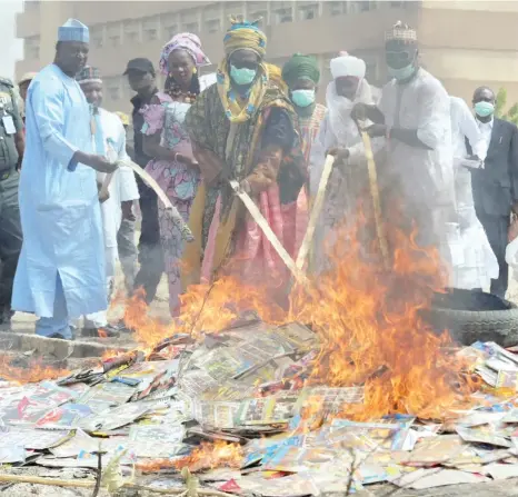  ?? Photo: Sani Maikatanga ?? National Film and Video Censors Board’s Executive Director, Alh. Adedayo Thomas with the District Head of Dala, Turakin Kano, Alhaji Abdullahi Lamido Sanusi and other dignitarie­s, burn phonograph­y movies impounded by the board in Kano yesterday