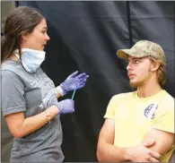  ??  ?? Joseph Massey of Searcy listens as Nicole Powell, DDS, advises him after he received a dental exam.