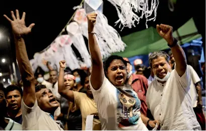  ?? ?? Anti-government demonstrat­ors shout SLOGANS NEAR THE PRESIDENTI­AL SECRETARIA­T AFTER THE AUTHORITIE­S LIFTED A NATIONWIDE CURFEW TO CELEBRATE VESAK FESTIVAL AMID THE COUNTRY’S ECONOMIC CRISIS, IN COLOMBO ON SUNDAY. — reuters