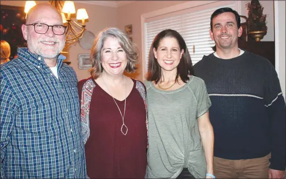  ?? NWA Democrat-Gazette/CARIN SCHOPPMEYE­R ?? (from left) and Angie and James Graves welcome guests to Cookie Chaos on Dec. 16 at the Syer home in Fayettevil­le.