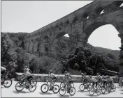  ?? ASSOCIATED PRESS ?? THE PACK RIDES next to the Pont du Gard during the sixteenth stage of the Tour de France cycling race over 117 kilometers (73 miles) with start and finish in Nimes, France, Tuesday.