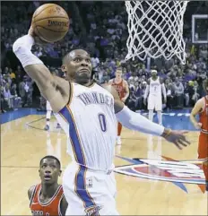  ?? Sue Ogrocki/Associated Press ?? ROLLING THUNDER Oklahoma City’s Russell Westbrook soars in for a dunk against the Bulls in Chicago Wednesday night.