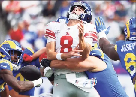  ?? Rich Schultz / Getty Images ?? The Rams’ Leonard Floyd strip sacks the Giants’ Daniel Jones in the first quarter on Sunday at MetLife Stadium in East Rutherford, N.J.