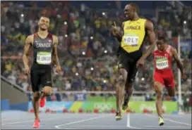  ?? DAVID J. PHILLIP — THE ASSOCIATED PRESS FILE ?? Jamaica’s Usain Bolt, right, gestures towards Canada’s Andre De Grasse after the finish of the men’s 200-meter semifinal during the 2016 Summer Olympics in Rio de Janeiro, Brazil.