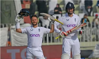  ?? Photograph: Aamir Qureshi/AFP/Getty Images ?? Zak Crawley applauds Ben Duckett after his opening partner followed him to a century on the opening day of the first Test against Pakistan.