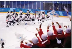  ?? AP/JAE C. HONG ?? North Korean supporters cheer Saturday for the unified women’s hockey team of players from North and South Korea before an 8-0 loss to Switzerlan­d in Gangneung, South Korea.