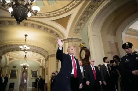  ?? ANDREW HARNIK — THE ASSOCIATED PRESS ?? President Donald Trump, accompanie­d by Vice President Mike Pence, waves Wednesday to members of the media as he arrives for a Senate Republican Policy lunch on Capitol Hill in Washington.