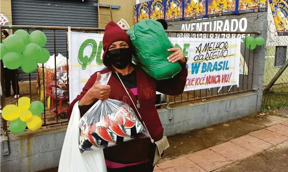  ?? Simoni Saris ?? Moradora do Vista Bela recebe alimentos e cobertor: associação de bairro e ONG Centro de Apoio Coração Solidário realizaram campanha