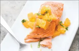  ?? The Associated Press ?? This recipe for Oven-Roasted Salmon with Tangerine and Ginger Relish appears in the cookbook “Nutritious Delicious.”