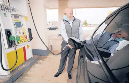  ?? SENNE/AP STEVEN ?? Jeremy Heskett pumps gasoline Feb. 18 in Westwood, Massachuse­tts. Gas prices have been on the rise for nearly a year.