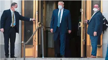  ?? — AFP ?? Trump leaves the Walter Reed Medical Center in Bethesda, Maryland, on Oct 5 after a three-day stay where he received a number of treatments for Covid-19.