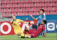  ??  ?? Qatar’s goalkeeper Mohammed al Bakri and defender Tarek Salman vie for the ball against a Japanese player during their AFC U23 Group B match on Wednesday.