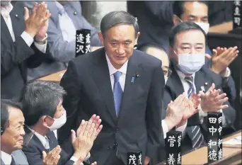  ?? KOJI SASAHARA — THE ASSOCIATED PRESS ?? Yoshihide Suga is applauded after being elected as Japan’s new prime minister at