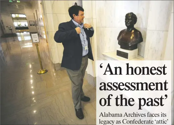  ?? (AP/Jay Reeves) ?? Steve Murray, director of the Alabama Department of Archives and History, pauses by a bust of former director Marie Bankhead Owen in Montgomery, Ala. Murray and other current leaders of the agency are confrontin­g the legacy of Owen, an ardent supporter of the “lost cause” version of Civil War history, as the nation grapples with the legacy of racial injustice.