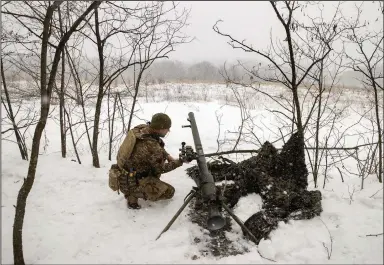  ?? (The New York Times/Tyler Hicks) ?? A Ukrainian soldier operates an anti-tank gun Wednesday on the front lines in the Bahkmut region of eastern Ukraine.
