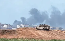  ?? AMIR COHEN/REUTERS ?? An Israeli tank holds a position as smoke rises in the Gaza Strip on Monday amid some of the most intense fighting seen in weeks.