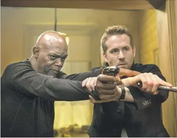  ?? Jack English Summit Entertainm­ent and Millenium Media ?? SAMUEL L. JACKSON, left, is a wanted hitman under Ryan Reynolds’ character’s protection in the film.