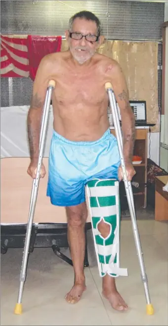  ??  ?? Top End traveller Doug Edwards, who had a serious motorbike accident in The Philippine­s, takes a step towards recovery, albeit on crutches