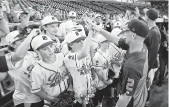  ?? Karen Warren / Staff photograph­er ?? Astros shortstop Carlos Correa and third baseman Alex Bregman high-fived members of Post Oak Little League on Friday at Minute Maid Park before they headed to the Little League World Series.