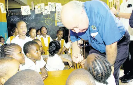  ??  ?? Oliver Clarke, then chairman of Jamaica National Small Business Loans Limited (JNSBL), has the attention of students of St Neva’s Day Care and Preparator­y School, located on Barnett Street in Montego Bay. Clarke was among a group of JNSBL board directors, staff, and Montego Bay business leaders who visited the school and other business places of several JNSBL clients.