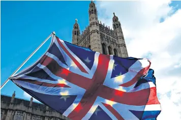  ??  ?? The Union and European flags fly in apparent synchrony in Westminste­r after the Brexit divorce deal was clarified yesterday