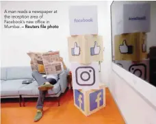  ??  ?? A man reads a newspaper at the reception area of Facebook’s new office in Mumbai. — Reuters file photo