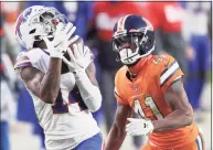  ?? Matthew Stockman / Getty Images ?? The Bills’ Stefon Diggs makes a reception past the Broncos’ De’Vante Bausby on Dec. 19.