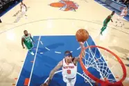  ??  ?? NATHANIEL S. BUTLER/GETTY IMAGES Michael Beasley (C) of the New York Knicks goes up for the basket in an NBA Eastern Conference tie against Boston Celtics at New York’s Madison Square Garden on December 21, 2017.