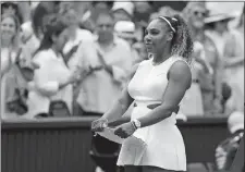  ?? TIM IRELAND/AP PHOTO ?? Serena Williams holds her second place trophy after losing to Simona Halep in the women’s singles final on Saturday in the Wimbledon Tennis Championsh­ips at London.