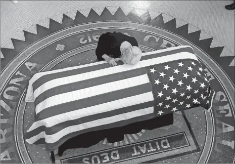  ?? ROSS D. FRANKLIN/AP PHOTO ?? Cindy McCain, wife of Sen. John McCain, R-Ariz., lays her head on his casket during a memorial service at the Arizona Capitol on Wednesday in Phoenix.