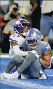  ?? (AP/Duane Burleson) ?? Detroit Lions wide receiver Amon- Ra St. Brown catches the game-winning touchdown pass as time expires in front of Minnesota Vikings cornerback Cameron Dantzler on Sunday in Detroit.