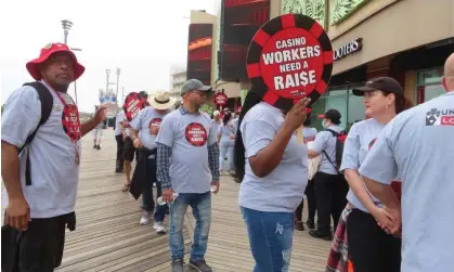  ?? Photograph: Wayne Parry/AP ?? Members of Local 54 of the Unite Here casino workers union picket outside the Tropicana casinoin Atlantic City, New Jersey, on 1 June.