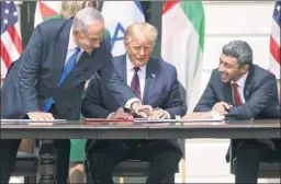  ?? ?? Revolution­ary: Trump (center) signs the Abraham Accords with Israeli PM Benjamin Netanyahu (left) and UAE Foreign Minister Abdullah bin Zayed Al Nahyan.
