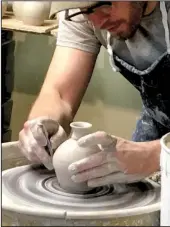  ?? TNS/MARY ANN ANDERSON ?? Pigeon River Pottery at the Old Mill in Pigeon Forge, Tenn., features artisans hard at work at their craft. The pottery collection features hundreds of pieces.