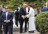  ?? SUSAN WALSH ?? President Donald Trump talks with the Rev. D. Andrew Olivo as he arrives Sunday at St. John’s Church in Washington.