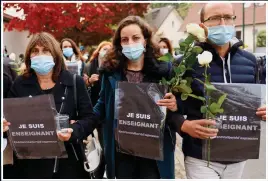  ??  ?? VIGIL: Shocked colleagues of beheaded teacher Samuel Paty, left, protest yesterday. Below: Body of man thought to be the terrorist