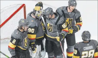  ??  ?? Knights teammates congratula­te goalkeeper Robin Lehner (90) after the club’s 5-3 victory Monday over Dallas in the first Western Conference playoff round-robin game at Rogers Place in Edmonton, Alberta.