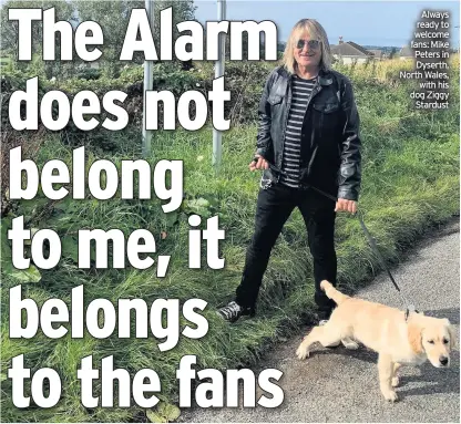  ??  ?? Always ready to welcome fans: Mike Peters in Dyserth, North Wales, with his dog Ziggy Stardust