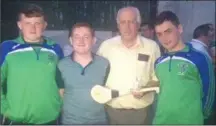 ??  ?? Guest players Jamie Gubbins and Colin Sherin who presented Maurice Sheil senior and junior with a miniature hurley embossed with both team crests.