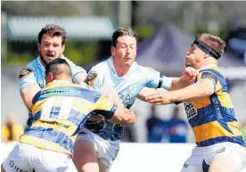  ??  ?? Northland winger Jordan Hyland tries to break the tackle of two Bay of Plenty defenders at Tauranga Domain.