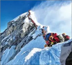  ?? @NIMSDAI PROJECT POSSIBLE/AFP ?? Mountainee­rs line up to stand at the summit of Mount Everest. The rush of climbers who risked frostbite and altitude sickness on May 22 marked one of the busiest days on the world’s highest mountain.