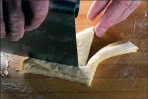  ?? Star Tribune/ TNS/ JERRY HOLT ?? Use a bench scraper or dough cutter to cut and shape the dough as desired.