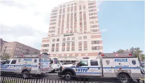  ?? JULIO CORTEZ/ASSOCIATED PRESS ?? Police vehicles converge on Bronx Lebanon Hospital in New York on June 30 after a gunman opened fire in the building. The shooter killed a doctor before turning the gun on himself.