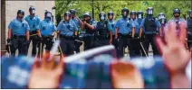  ?? KEREM YUCEL — GETTY IMAGES ?? Protesters are trapped between police and other protesters who gathered outside a Minneapoli­s police precinct on May 27 to protest the killing of George Floyd on May 25. Police fired rubber bullets and used tear gas to try to break up the protest.