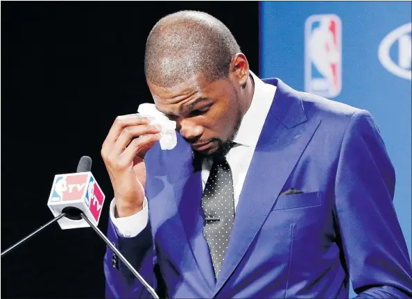  ?? — THE ASSOCIATED PRESS FILES ?? Oklahoma City’s Kevin Durant wipes away tears as he speaks during a news conference after the news that he had won the 2014 NBA Most Valuable Player award. He praised his mother, Wanda Pratt, for her sacrifices.